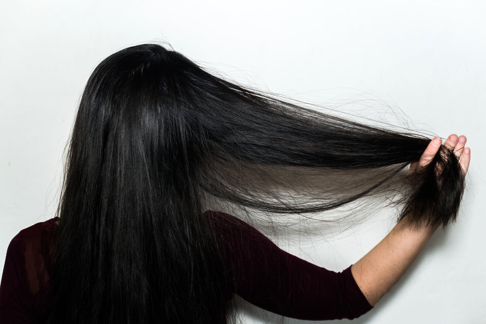 woman running fingers through hair